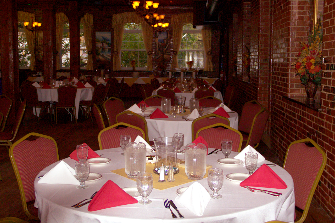 Table set with white tablecloth and red napkins